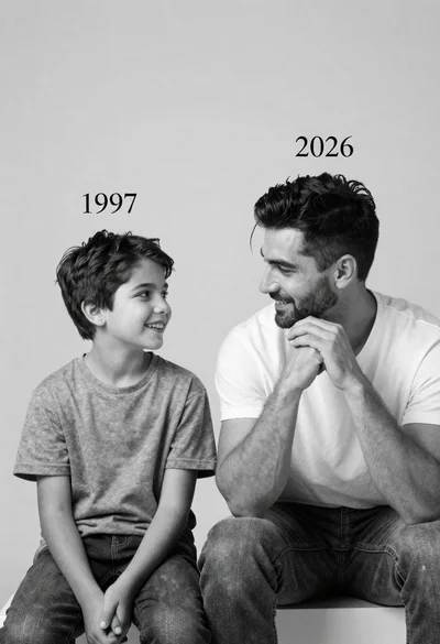 Black and white studio portrait of a smiling boy and an adult