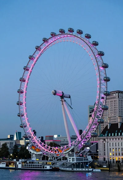 Wide view of london eye ferris wheel against twilight blue sky backdrop