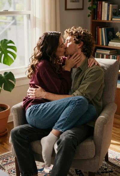 Couple kissing intimately in sunlit living room armchair setting