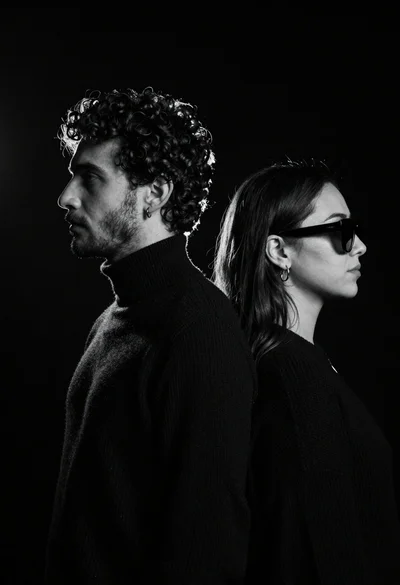 High contrast black and white profile portrait of man and woman in