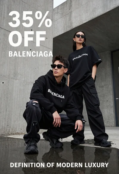 Two stylish models in black balenciaga streetwear posing in an urban concrete