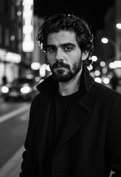 Black and white portrait of man in city night