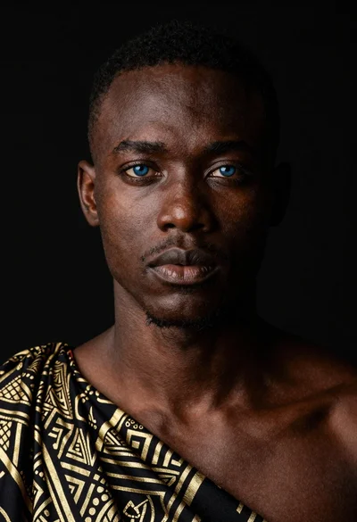 Black man portrait with blue eyes dramatic lighting