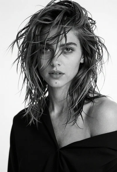 Black and white portrait of young woman with messy hair studio shot
