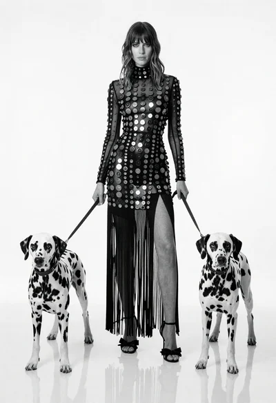 Full length black and white portrait of woman with two dalmatian dogs