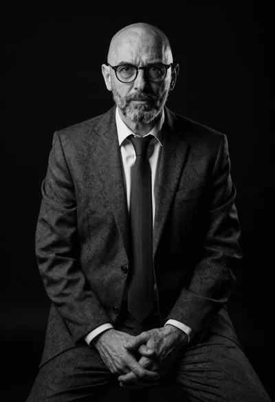 Black and white portrait of mature bald man in suit