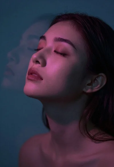 Moody portrait of woman with eyes closed head tilted back