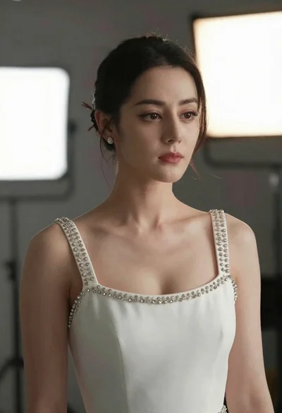 Close up portrait of woman in white gown against soft studio backdrop