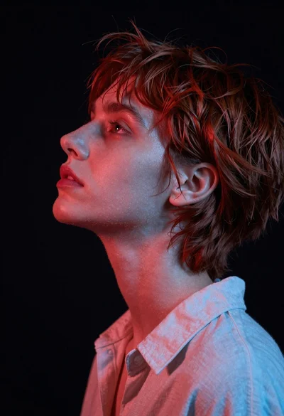 Close up profile portrait of woman with reddish brown hair looking upward