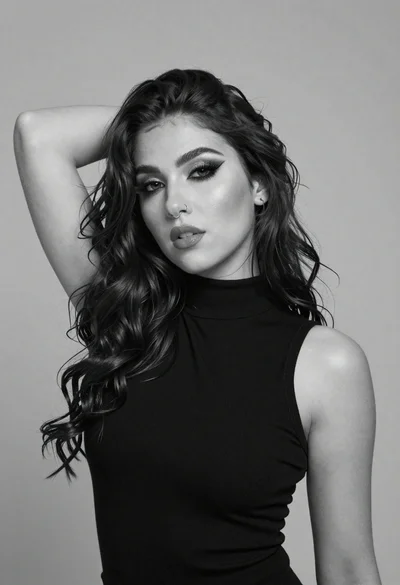 Black and white studio portrait of woman with long wavy hair