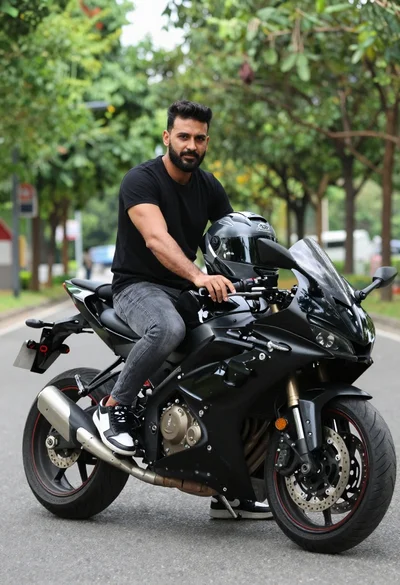Man sitting on black sport motorcycle on asphalt road
