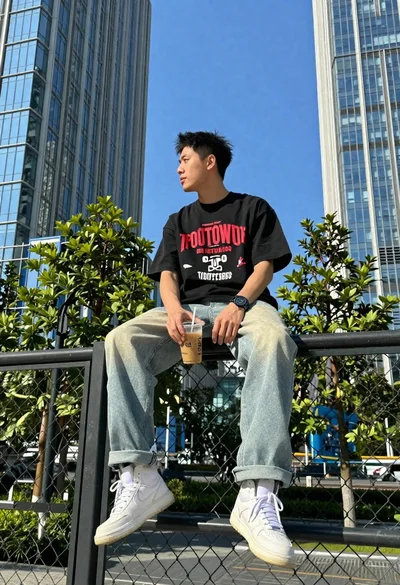 Young man on fence against modern city skyline