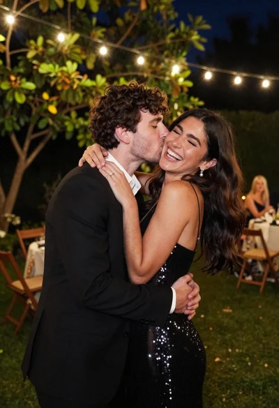 Couple embracing in an outdoor garden at night under string lights