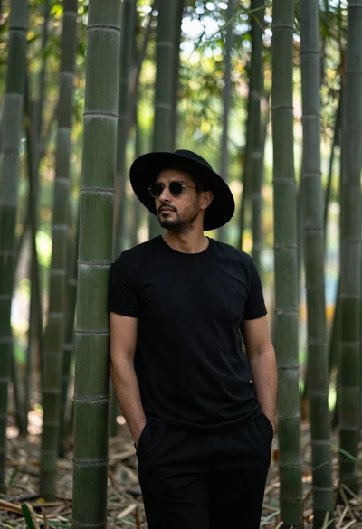 Man in black clothes standing in a bamboo forest