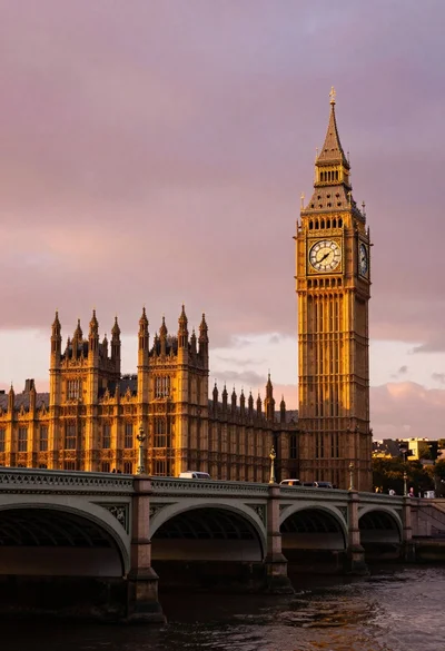 Wide view of palace westminster big ben tower at sunset with stone