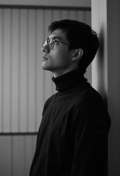 Black and white portrait of young man looking upward in profile