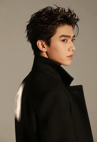 Close up portrait of young man in black coat