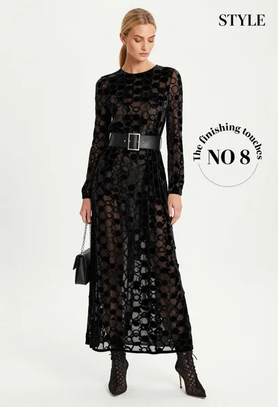 Full body fashion photograph of blonde woman in black velvet gown