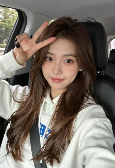 Young woman in white sweatshirt making peace sign inside car