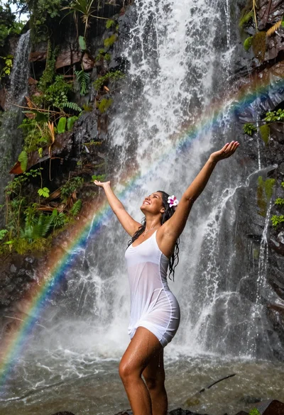Latin woman bathing under massive iguazu falls devils throat cascade