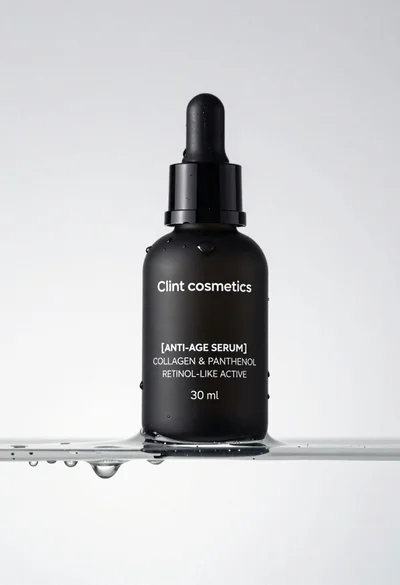 Macro shot of black serum bottle on floating water slab studio product