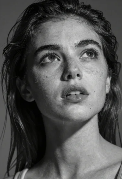 Monochrome portrait of young woman gazing upward